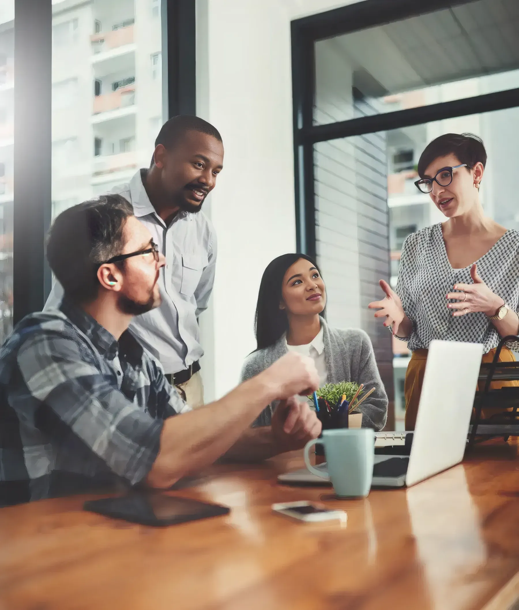 A benefits advisor in conversation with a small-business team around a table