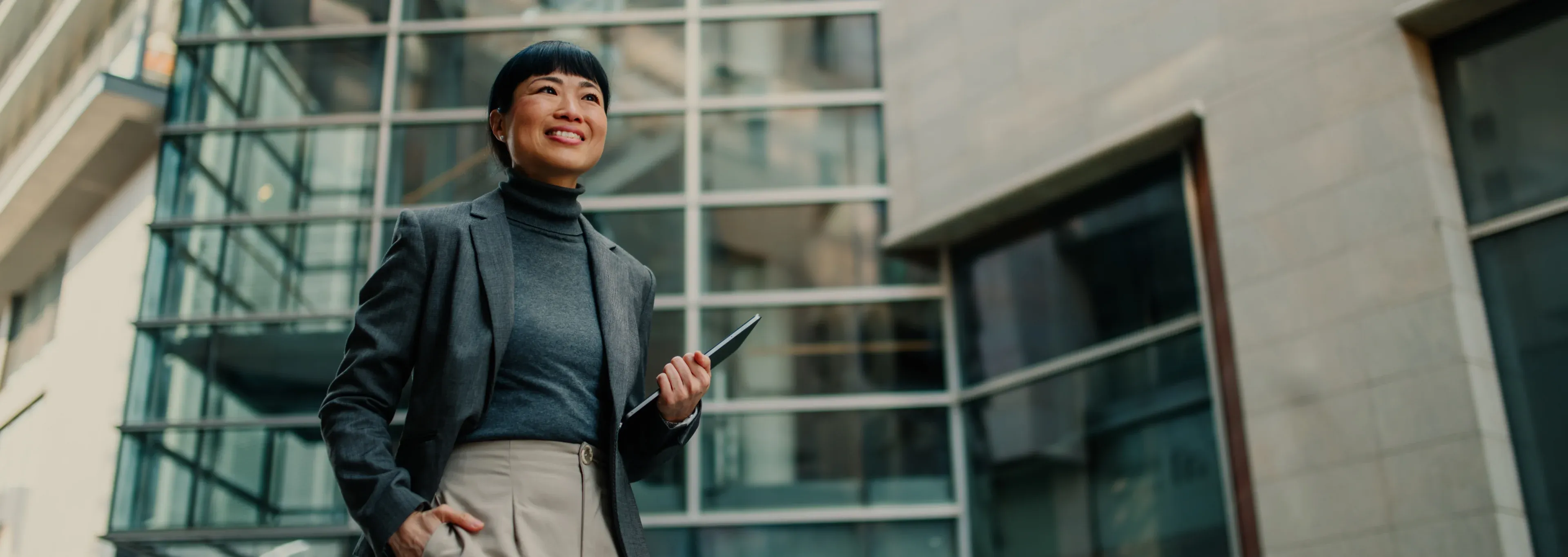 A benefits advisor outside a glass-facade office building