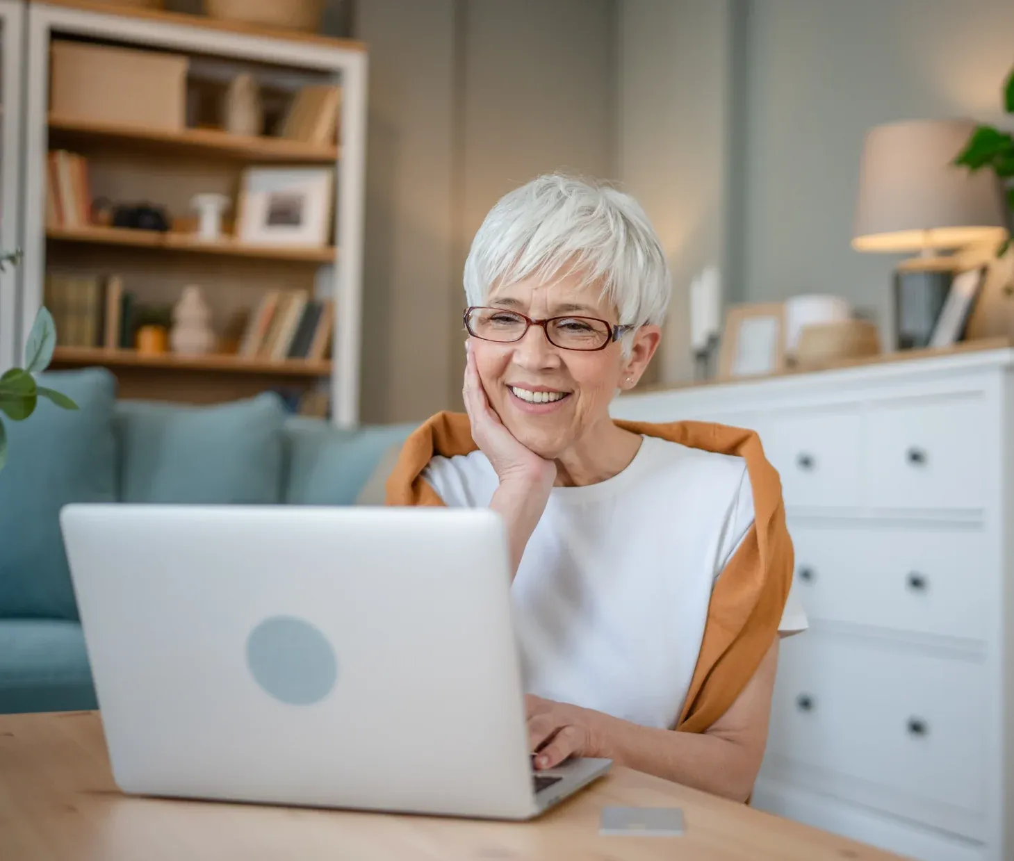 Smiling senior woman using a laptop at home